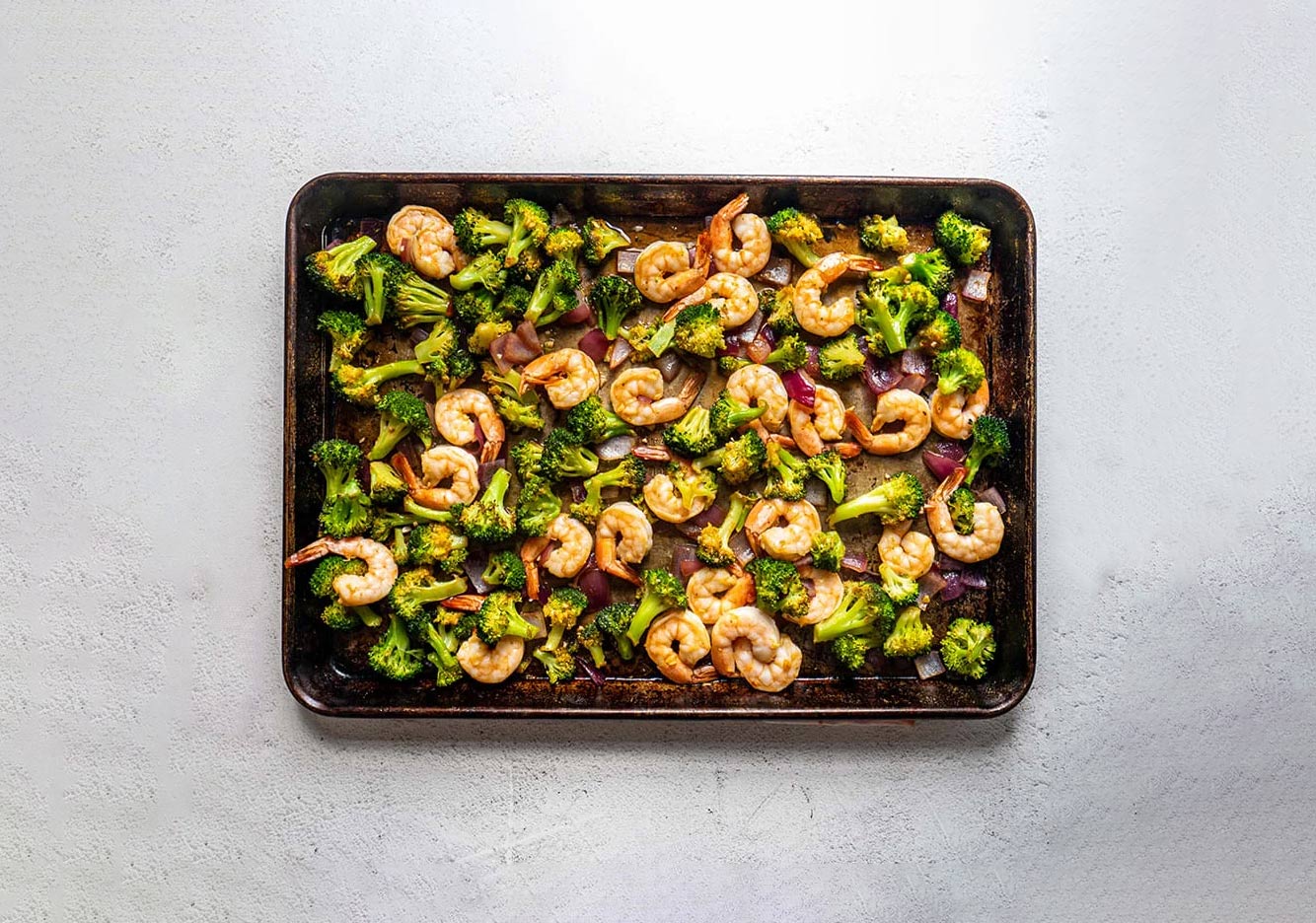 shrimp and broccoli in a tray